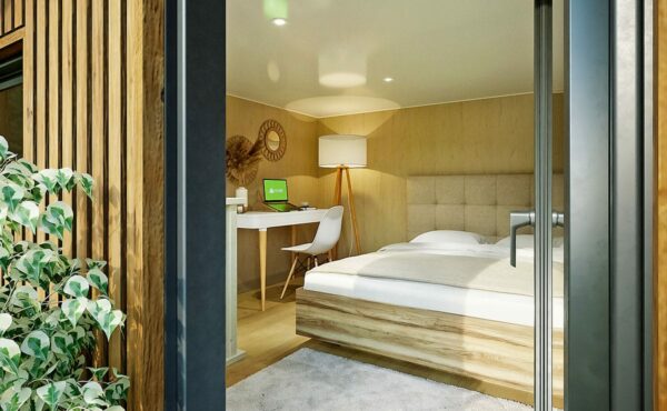 Un studio de jardin avec une chambre et un bureau